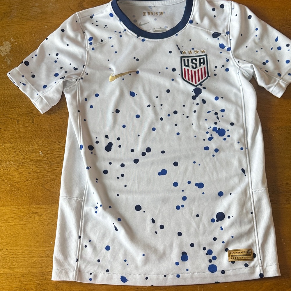 Nike Kids White Jersey with Blue Splatter and Gold Swoosh